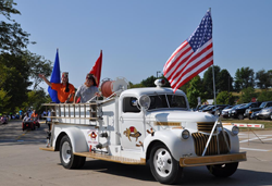 Red and yellow trolley with flags and Shriners decals